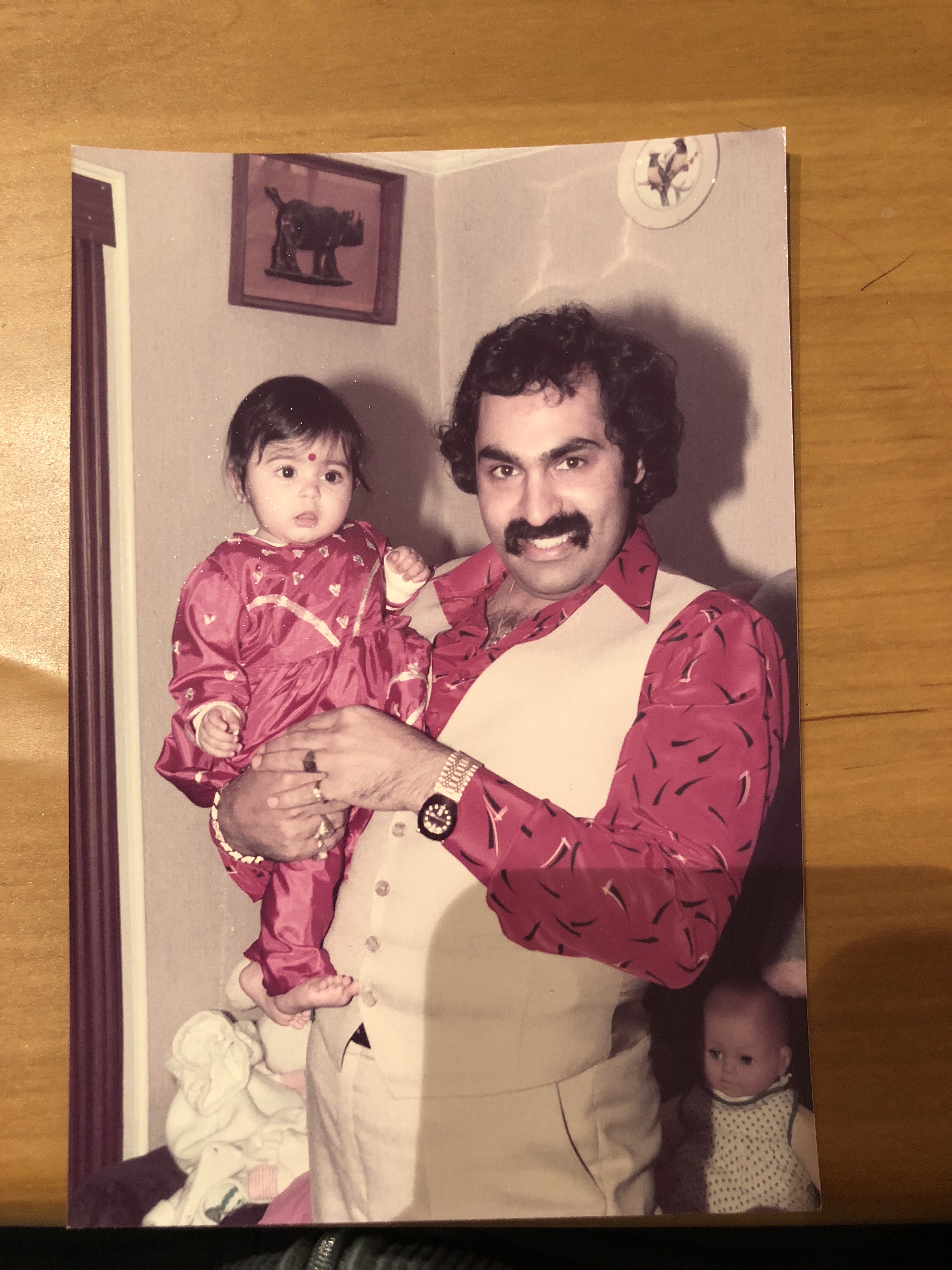 Photo of a man holding a baby.