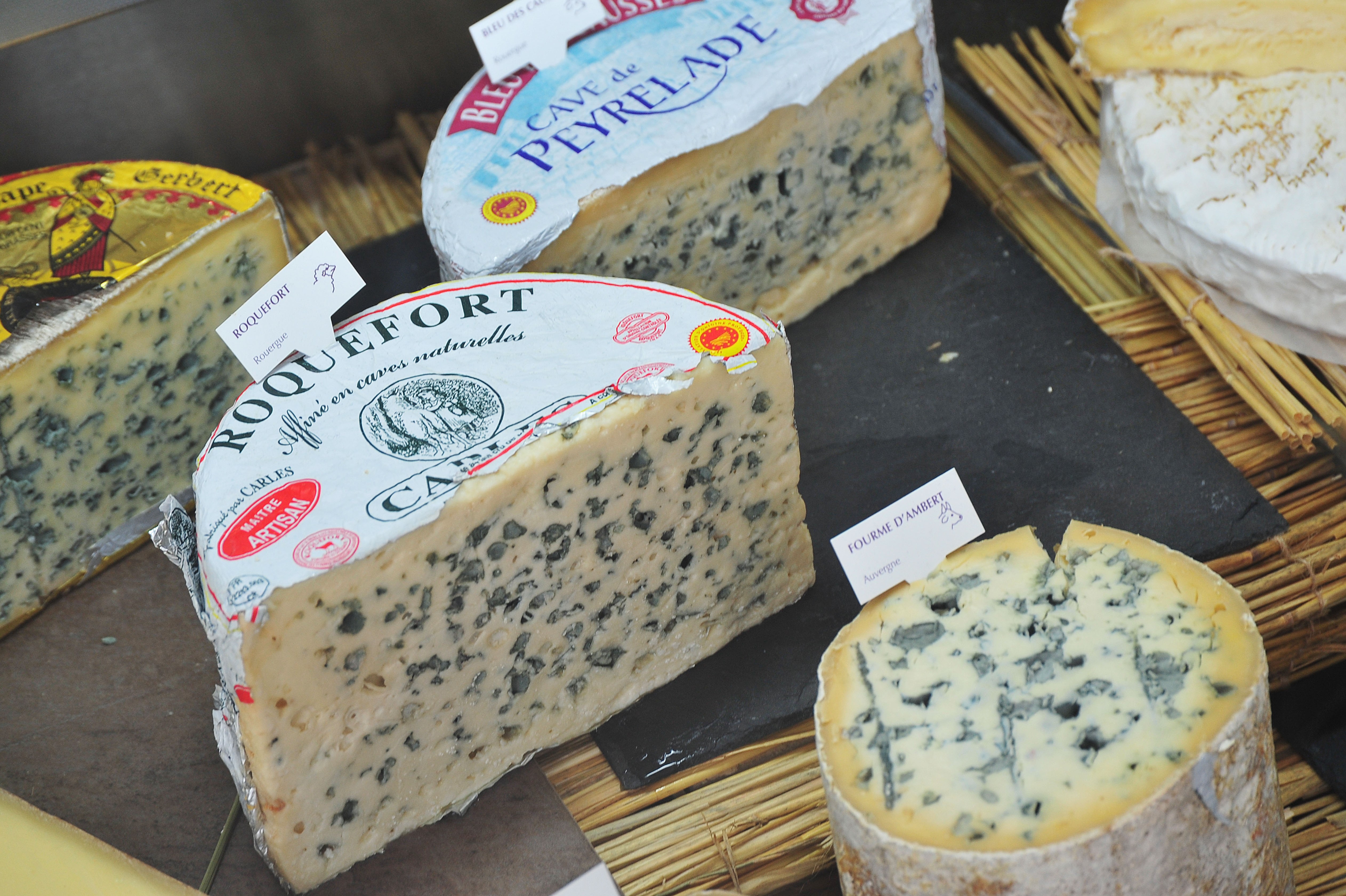 Assortment of blue cheeses on display at a fromagerie in Paris.
