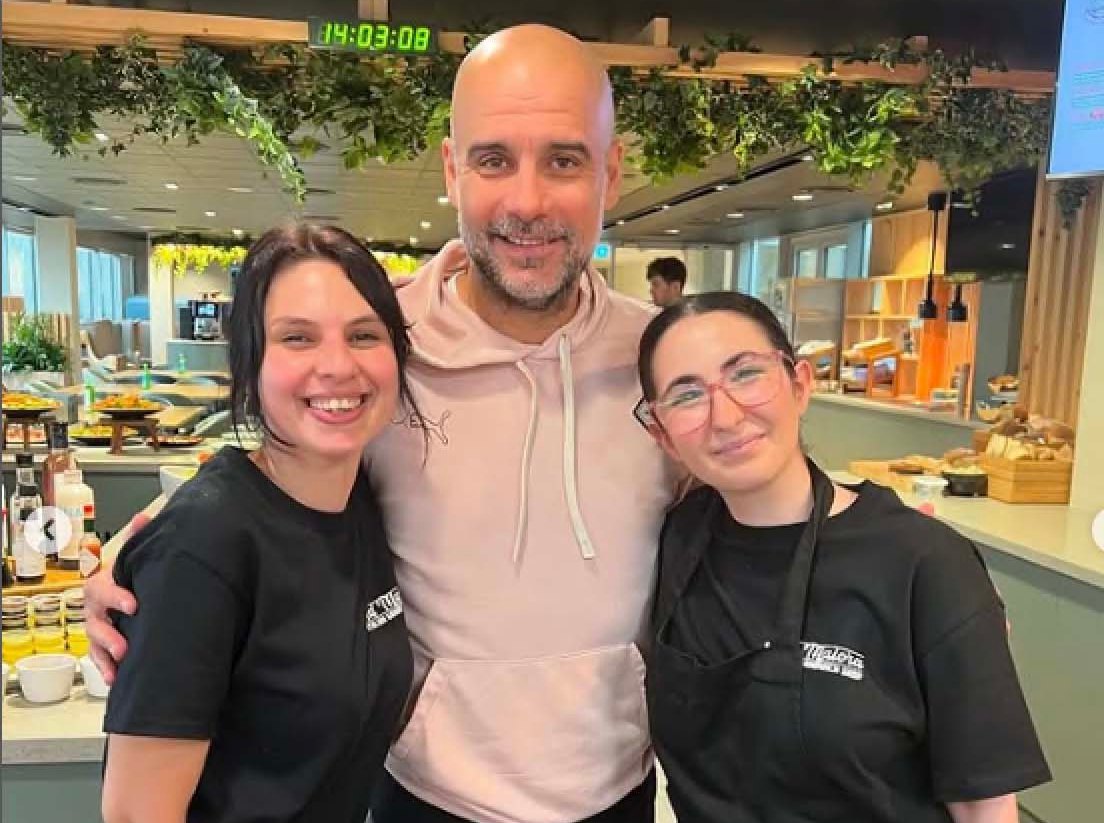 Photo of Pep Guardiola posing with two women at Ad Maiora Italian Sandwich Shop.